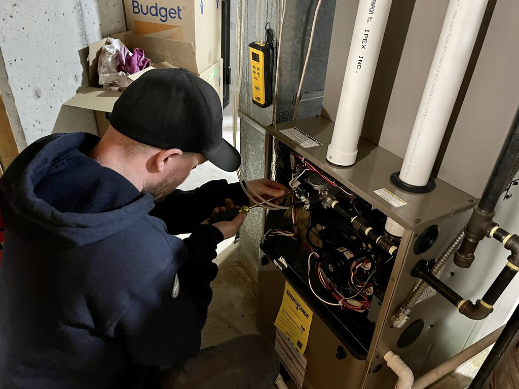 HVAC technician performing furnace repair